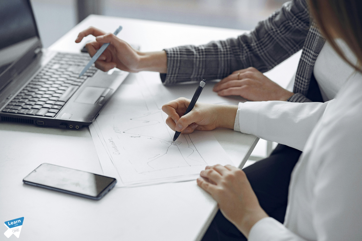 Two people working on laptop together