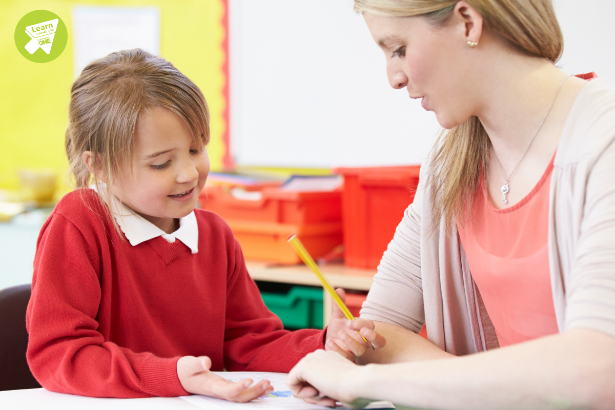 Teaching assistant helping child with school work